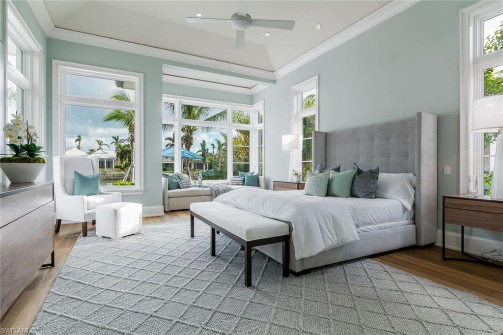 870 Nelson`s Walk Naples, FL 34102 - Photo 9 of 24 a spacious bedroom with a bed and a large window