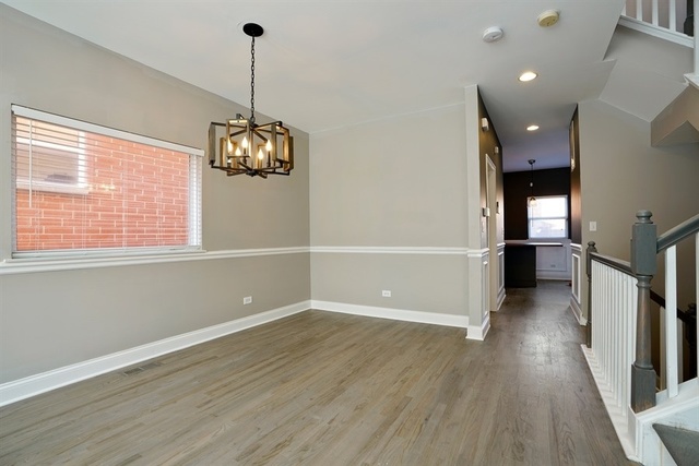 4152 South Berkeley Avenue Chicago, IL 60653 - Photo 4 of 15 a view of a room with wooden floor and windows