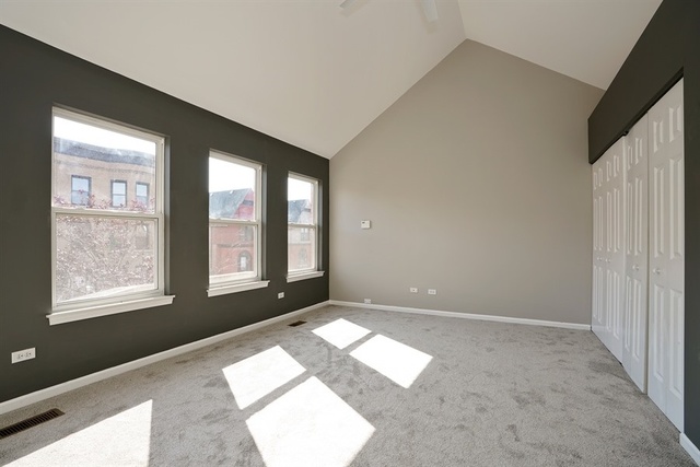 4152 South Berkeley Avenue Chicago, IL 60653 - Photo 8 of 15 a view of an empty room with a window