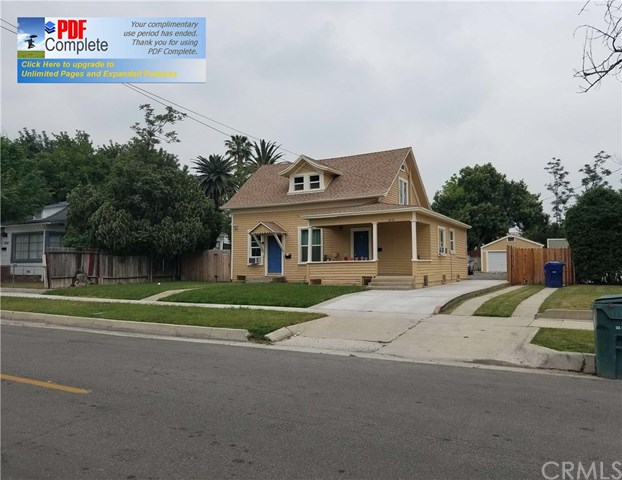4375 6th Street Riverside, CA 92501 - Photo 1 of 1 a front view of a house with a garden and parking