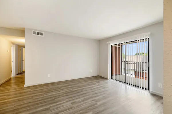a view of a room with wooden floor and window