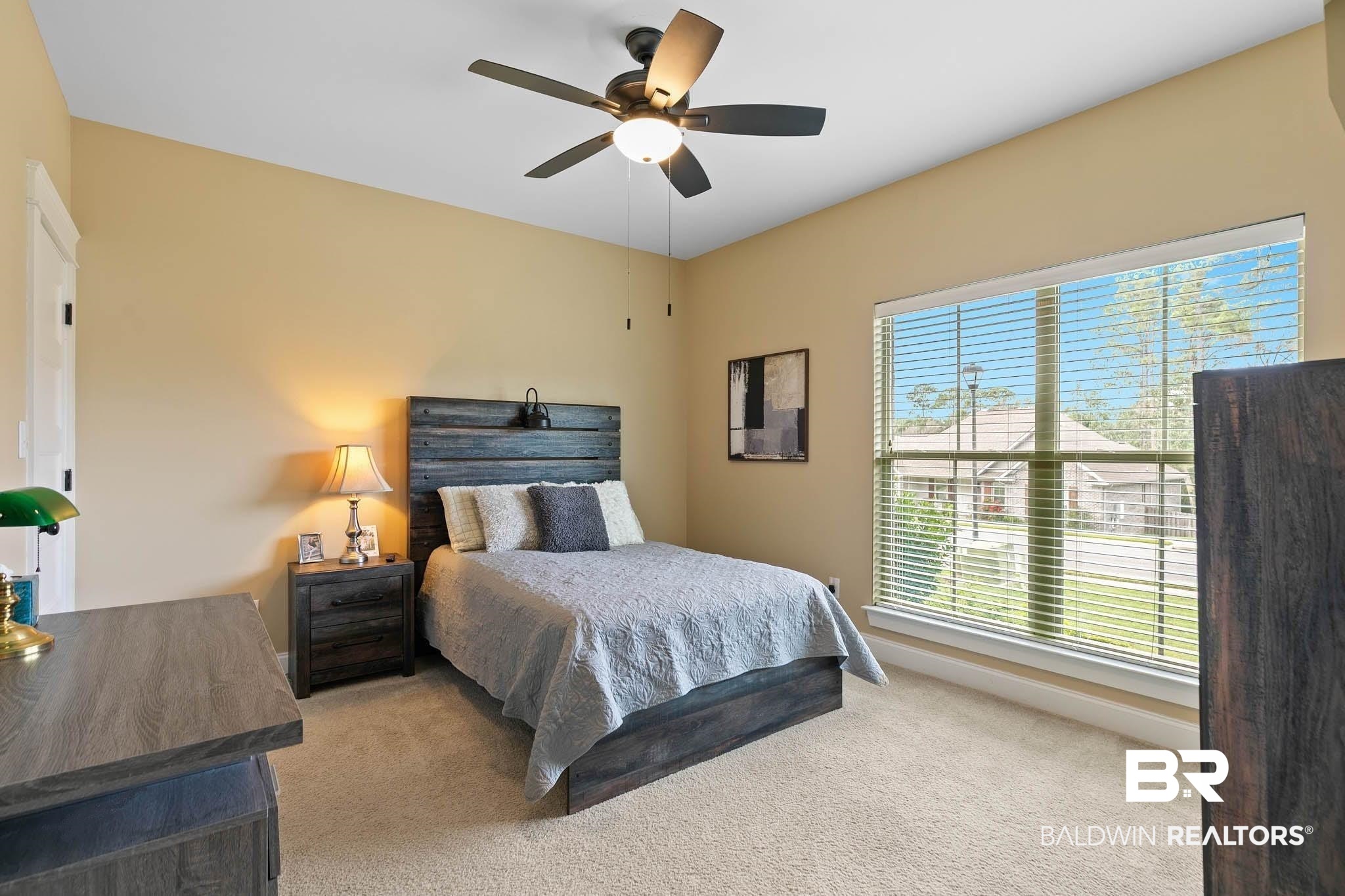 19740 Bunker Loop Fairhope, AL 36532 - Photo 26 of 33 Bedroom with light carpet and a ceiling fan