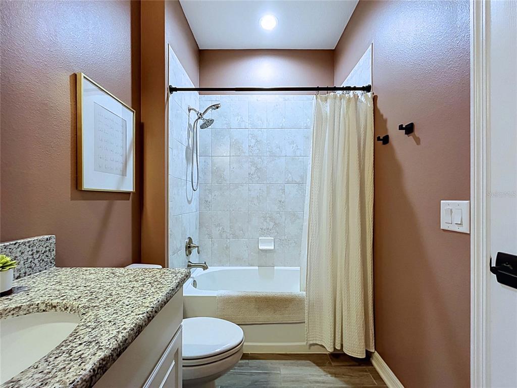 18078 Romanesque Court Spring Hill, FL 34610 - Photo 53 of 81 a bathroom with a granite countertop sink toilet and shower