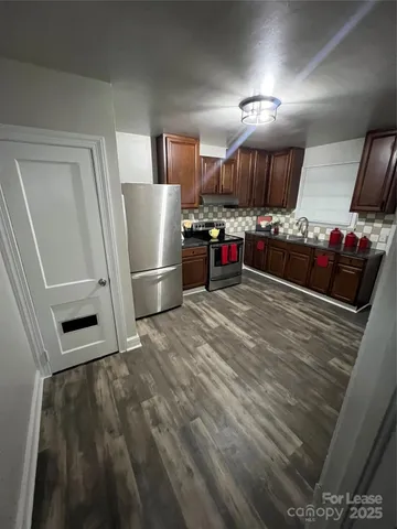 a view of a refrigerator in kitchen and wooden floor