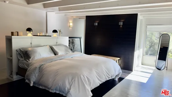 a bedroom with furniture and a flat screen tv