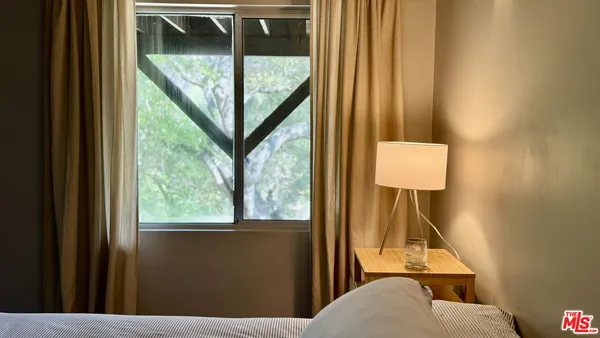 a view of a livingroom with furniture and a window