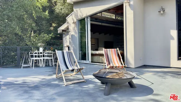 a view of a chairs and table in the balcony