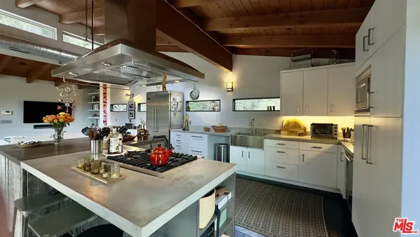 a kitchen with sink cabinets and appliances