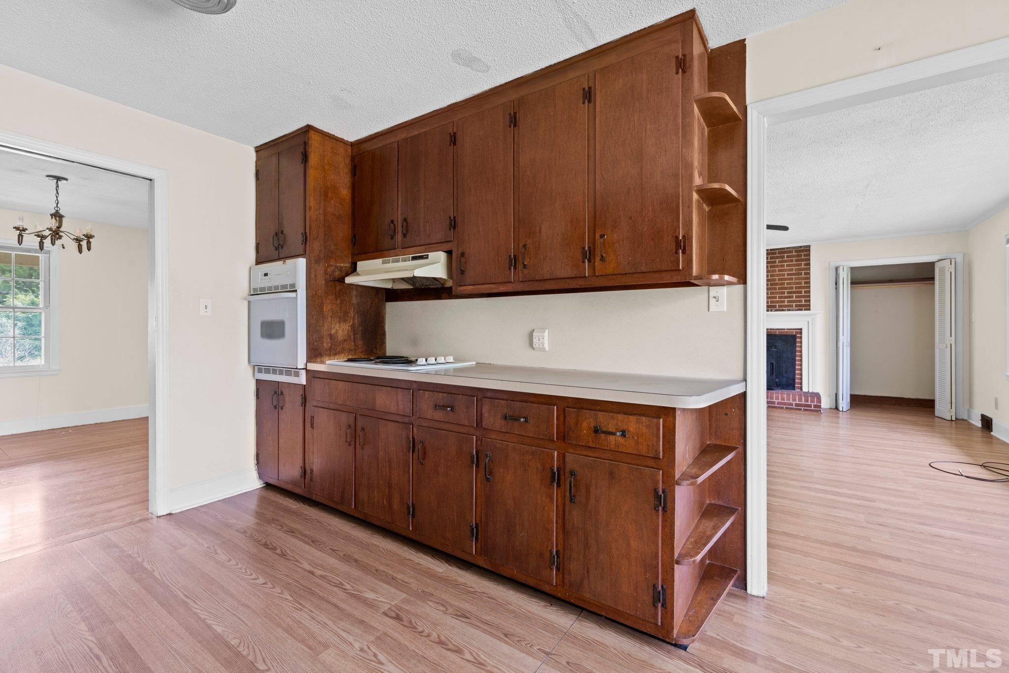 104 West Tally Ho Road Stem, NC 27581 - Photo 12 of 25 a kitchen with stainless steel appliances granite countertop wooden cabinets a refrigerator and a stove