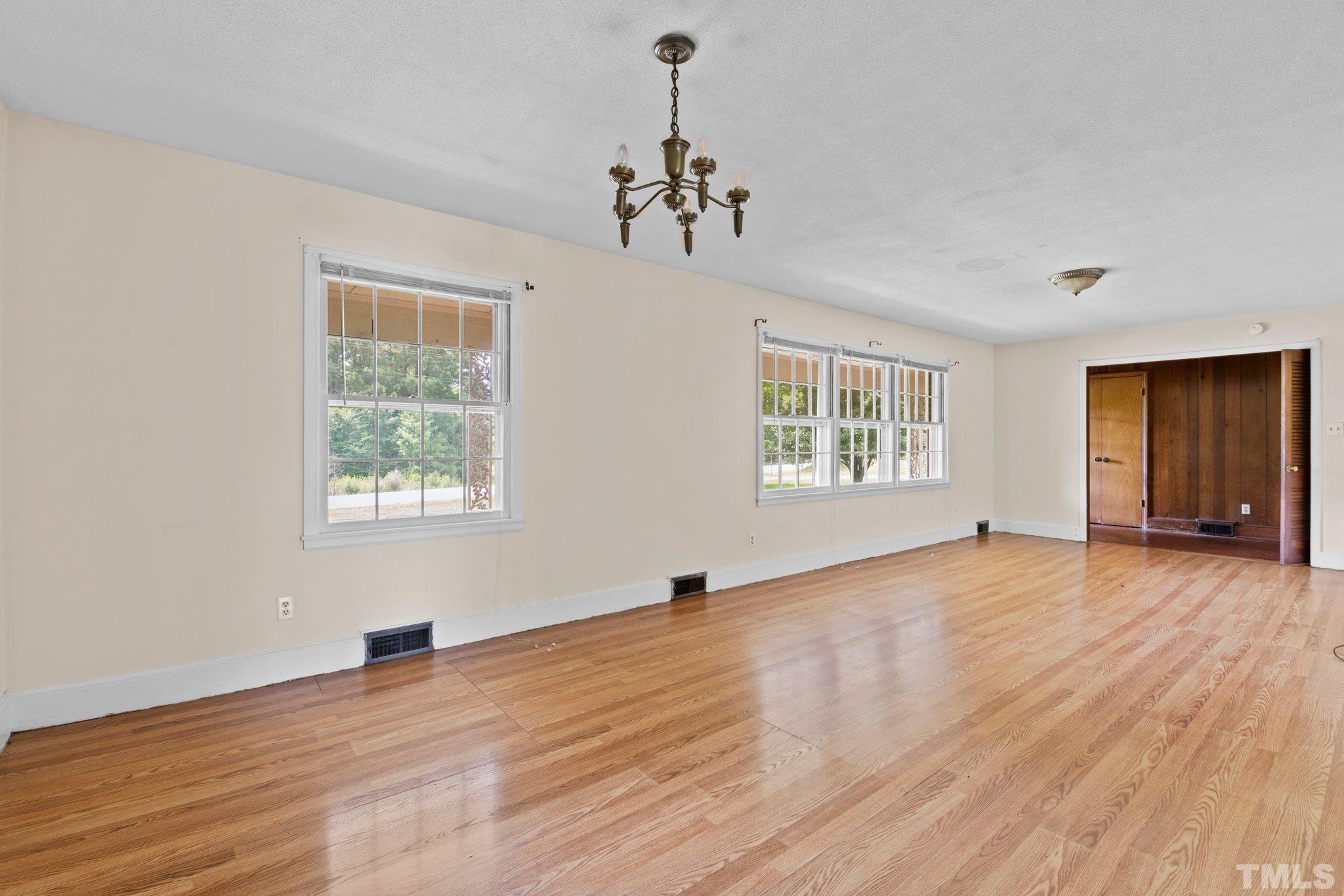 104 West Tally Ho Road Stem, NC 27581 - Photo 14 of 25 a view of an empty room with wooden floor and a window