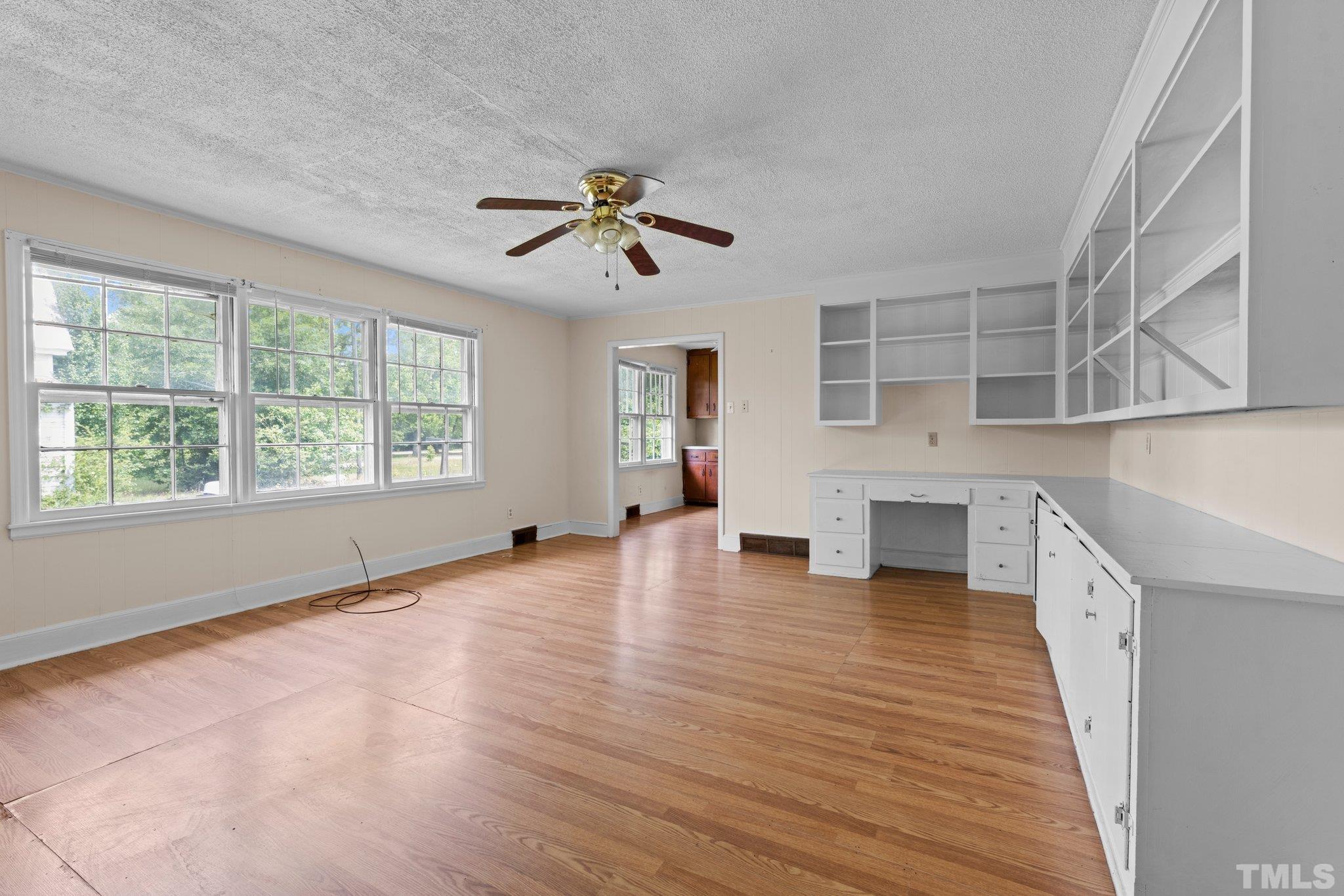 104 West Tally Ho Road Stem, NC 27581 - Photo 16 of 25 a view of empty room with wooden floor and fan