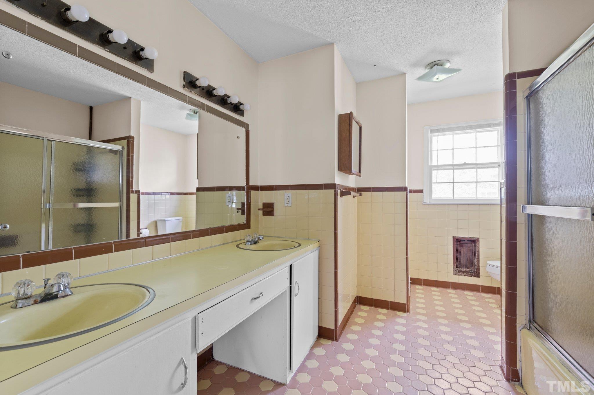 104 West Tally Ho Road Stem, NC 27581 - Photo 18 of 25 a bathroom with a sink and a mirror