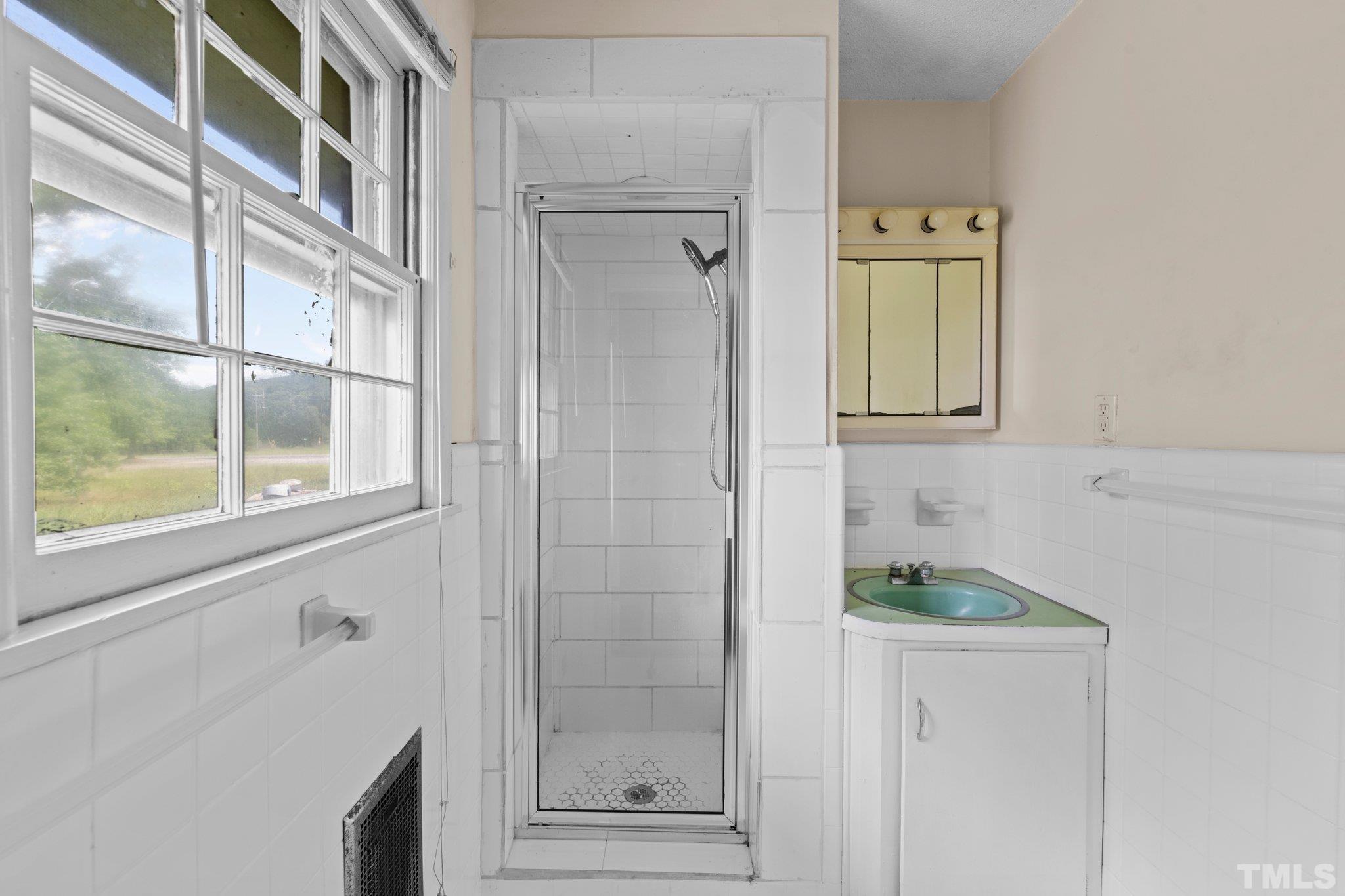 104 West Tally Ho Road Stem, NC 27581 - Photo 19 of 25 a bathroom with a shower and a window