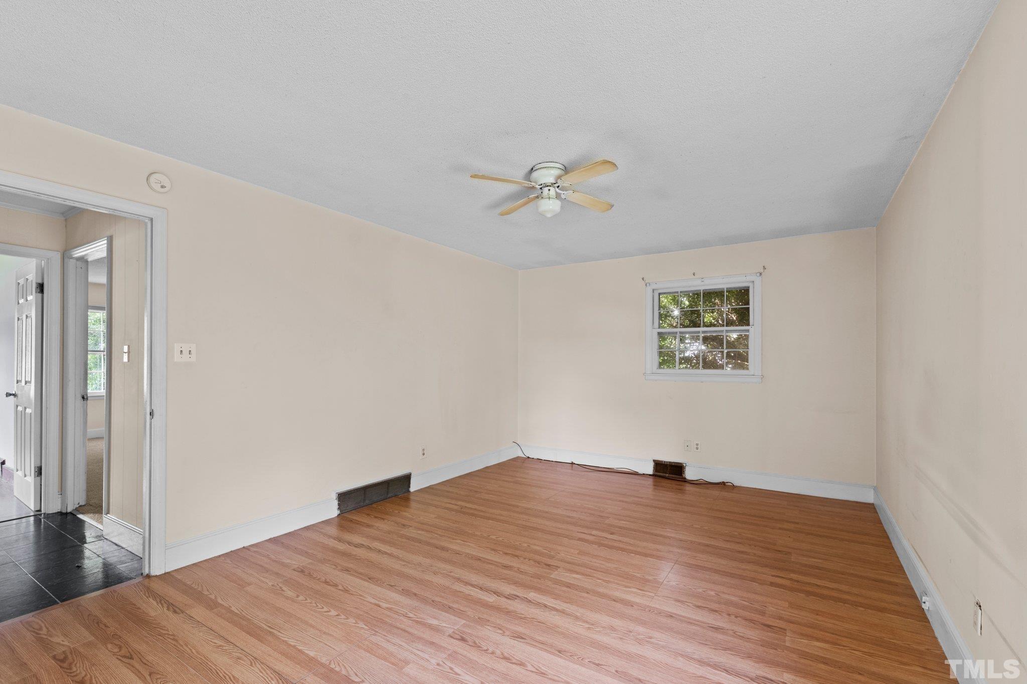 104 West Tally Ho Road Stem, NC 27581 - Photo 20 of 25 a view of a room with wooden floor and a ceiling fan