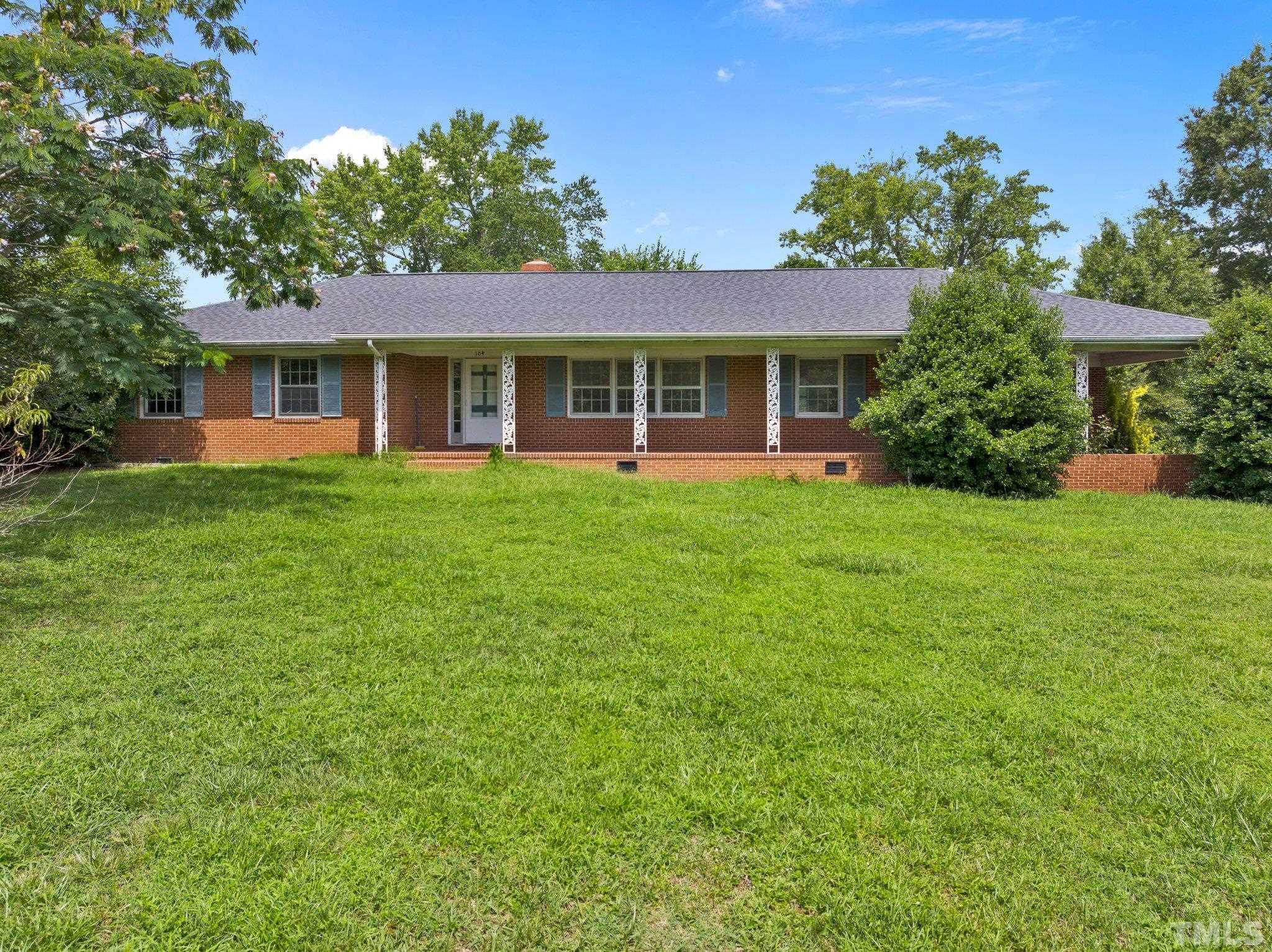 104 West Tally Ho Road Stem, NC 27581 - Photo 4 of 25 a front view of a house with a garden