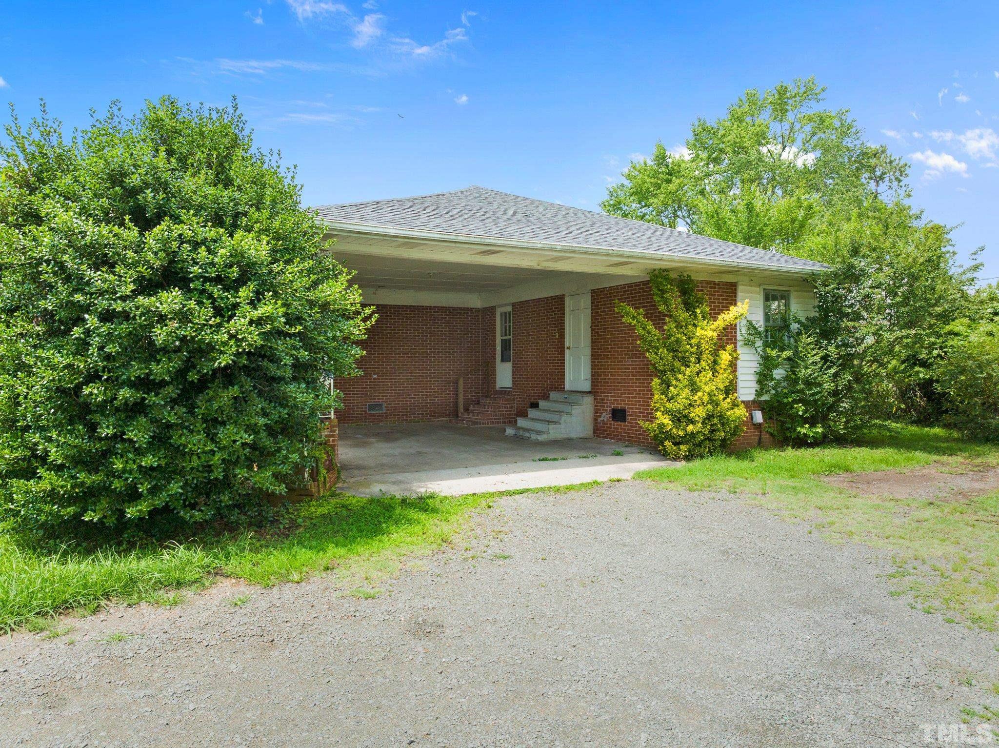 104 West Tally Ho Road Stem, NC 27581 - Photo 6 of 25 a front view of a house with garden