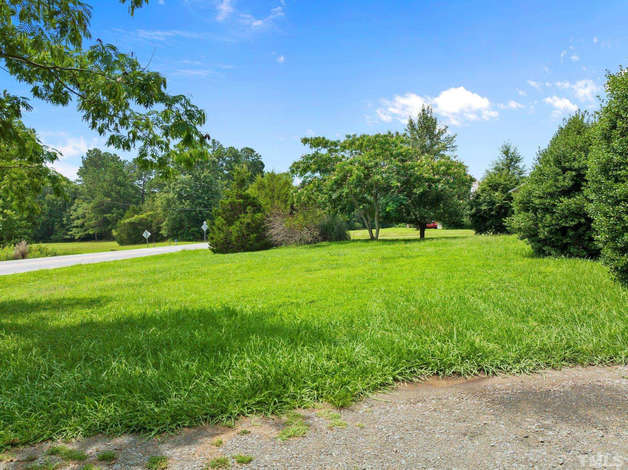 104 West Tally Ho Road Stem, NC 27581 - Photo 7 of 25 a view of grassy field with benches in the background