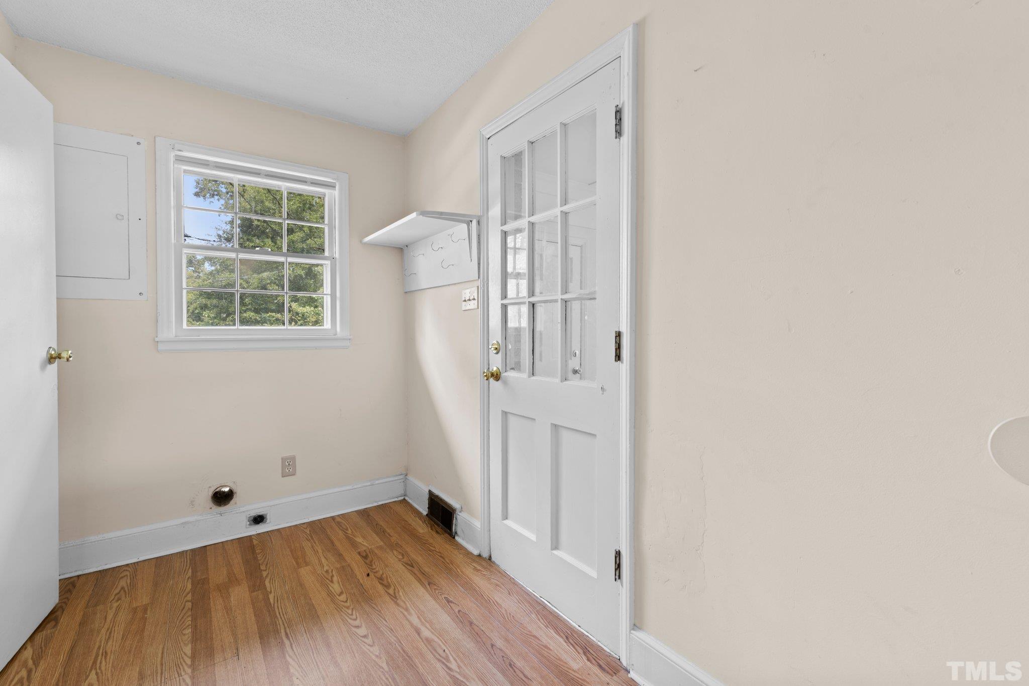 104 West Tally Ho Road Stem, NC 27581 - Photo 10 of 25 an empty room with wooden floor and windows