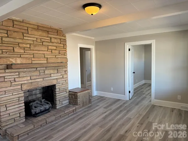 a view of livingroom with hardwood floor and a fireplace