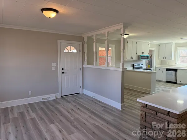 a view of a kitchen cabinets and wooden floor