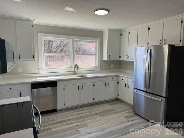 a kitchen with a refrigerator stove and sink