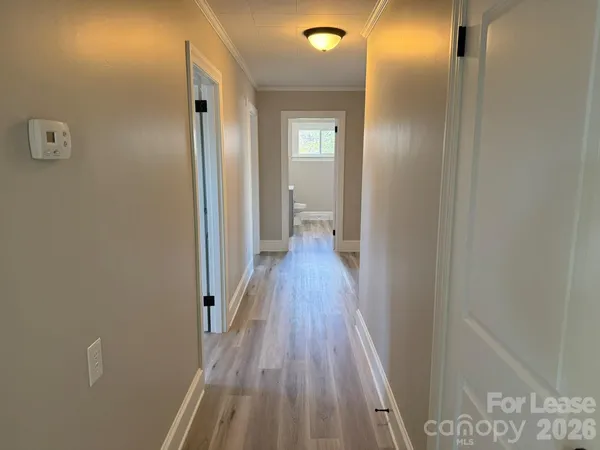 a view of a hallway with wooden floor