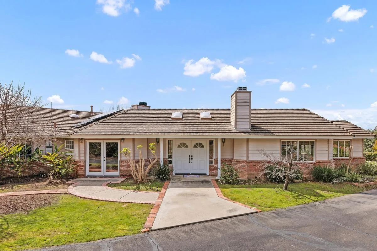15121 Country Hill Road Poway, CA 92064 - Photo 1 of 40 a front view of a house with a yard and porch