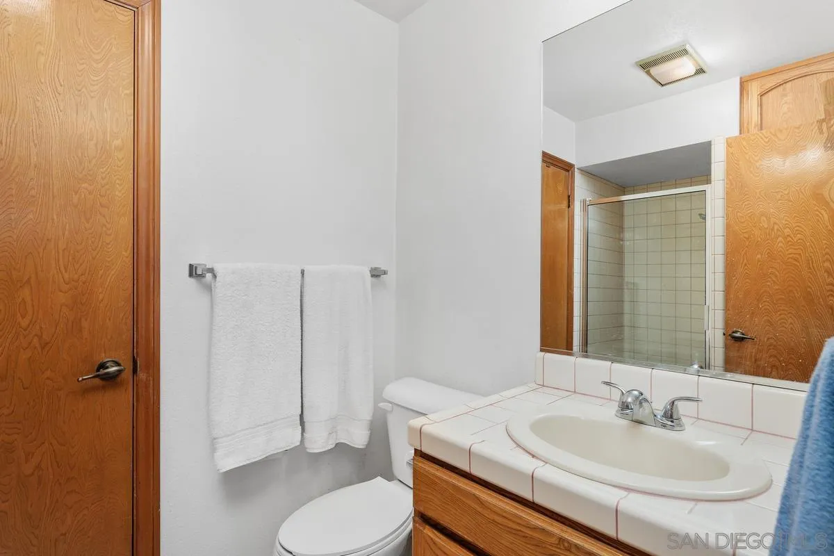 15121 Country Hill Road Poway, CA 92064 - Photo 18 of 40 a bathroom with a sink toilet and shower