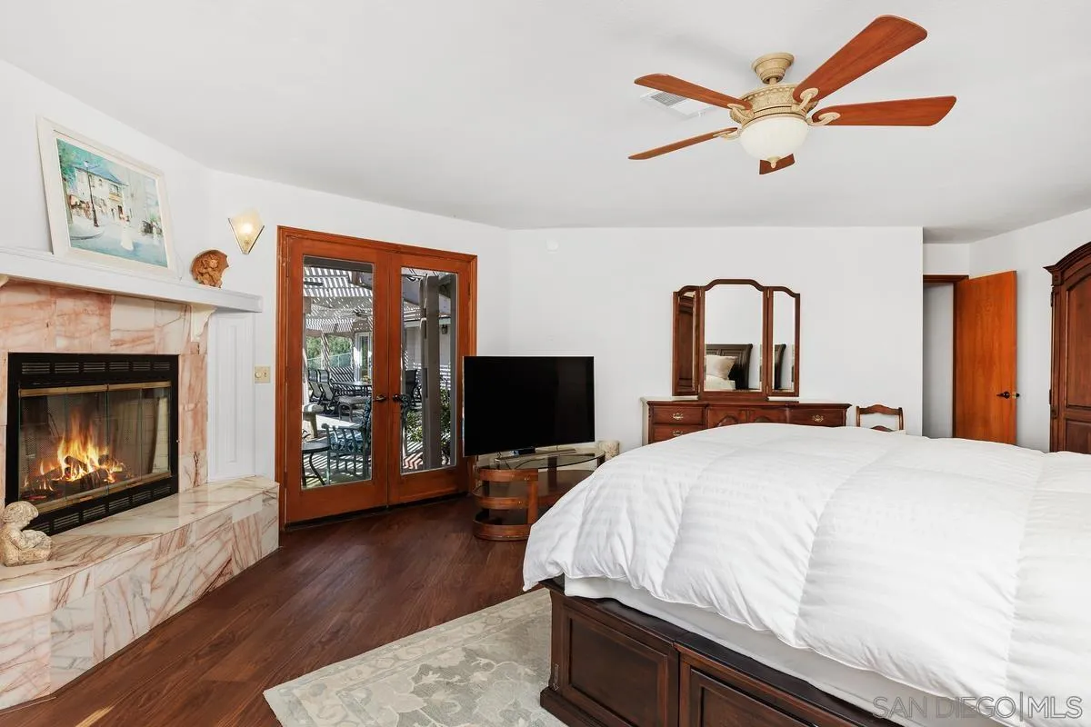 15121 Country Hill Road Poway, CA 92064 - Photo 20 of 40 a bedroom with a bed and a fireplace