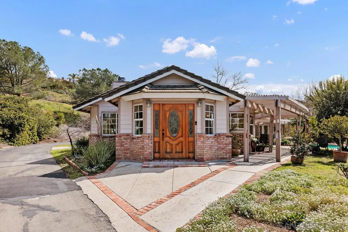 15121 Country Hill Road Poway, CA 92064 - Photo 2 of 40 a front view of a house with garden