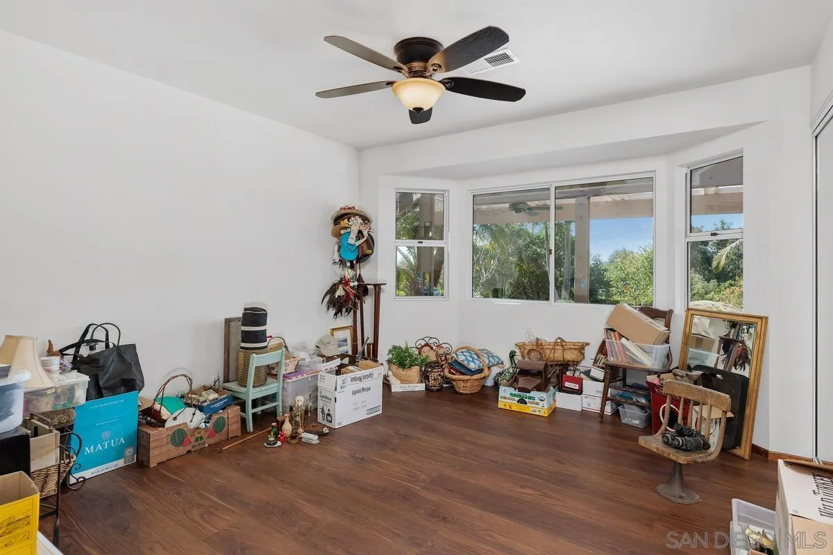 15121 Country Hill Road Poway, CA 92064 - Photo 26 of 40 a living room with furniture and a wooden floor