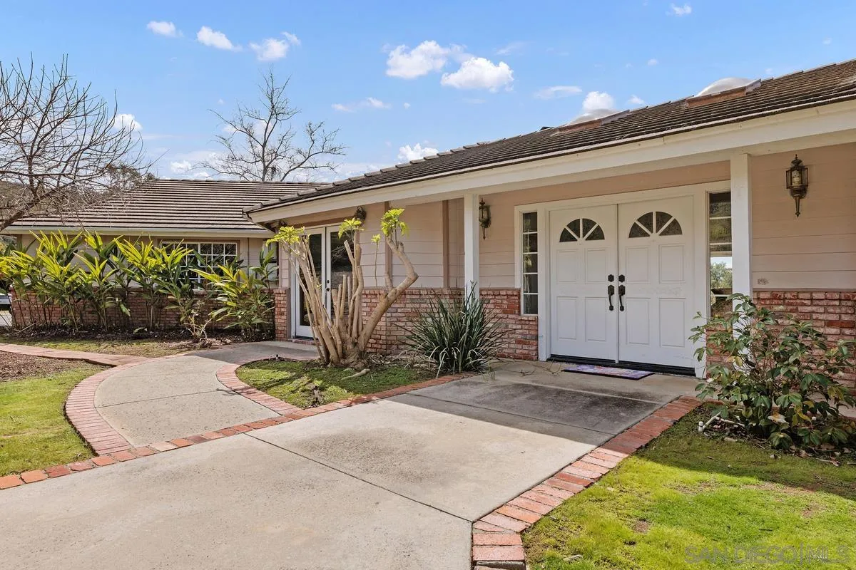 15121 Country Hill Road Poway, CA 92064 - Photo 3 of 40 a front view of a house with garden