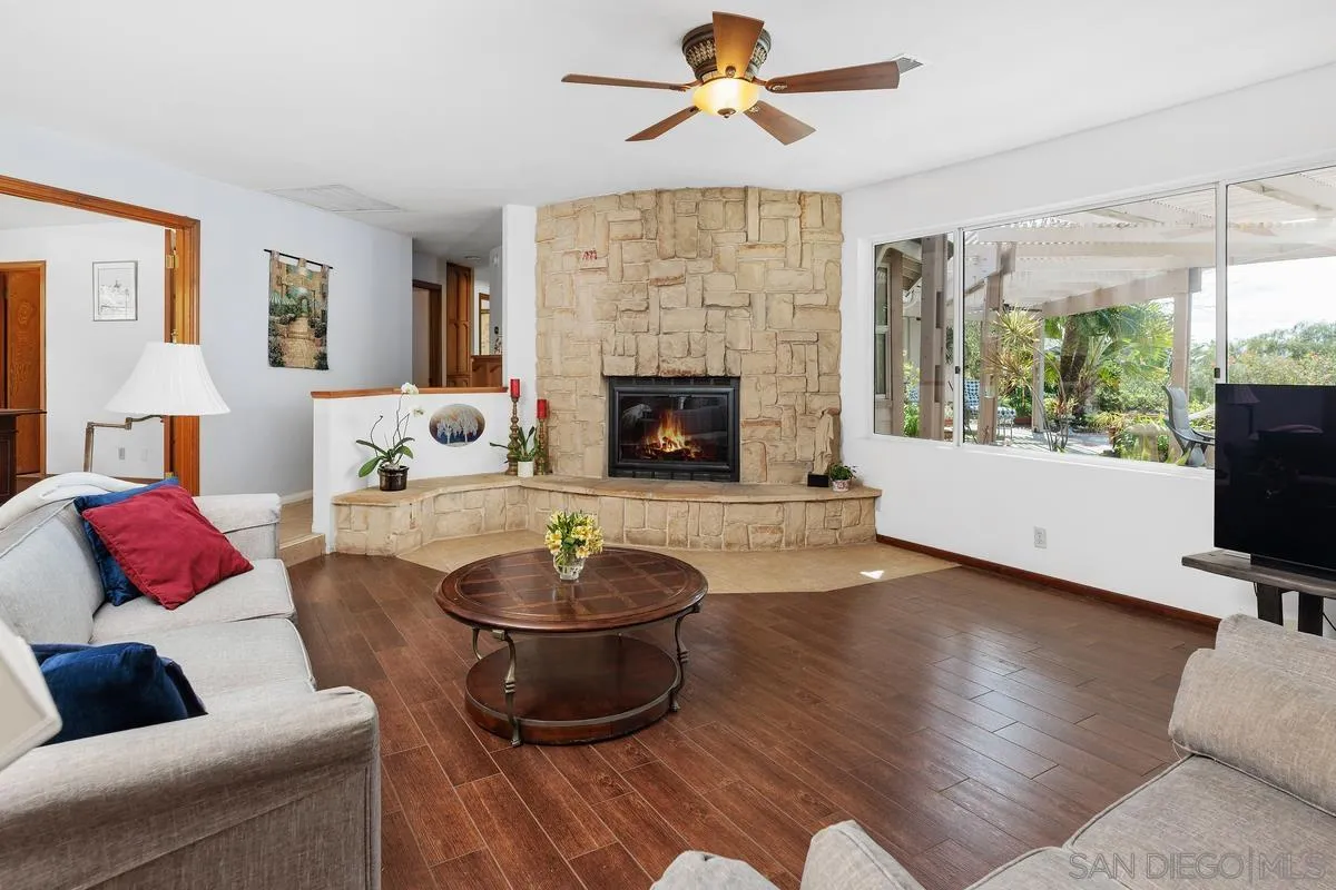 15121 Country Hill Road Poway, CA 92064 - Photo 6 of 40 a living room with furniture and a fireplace