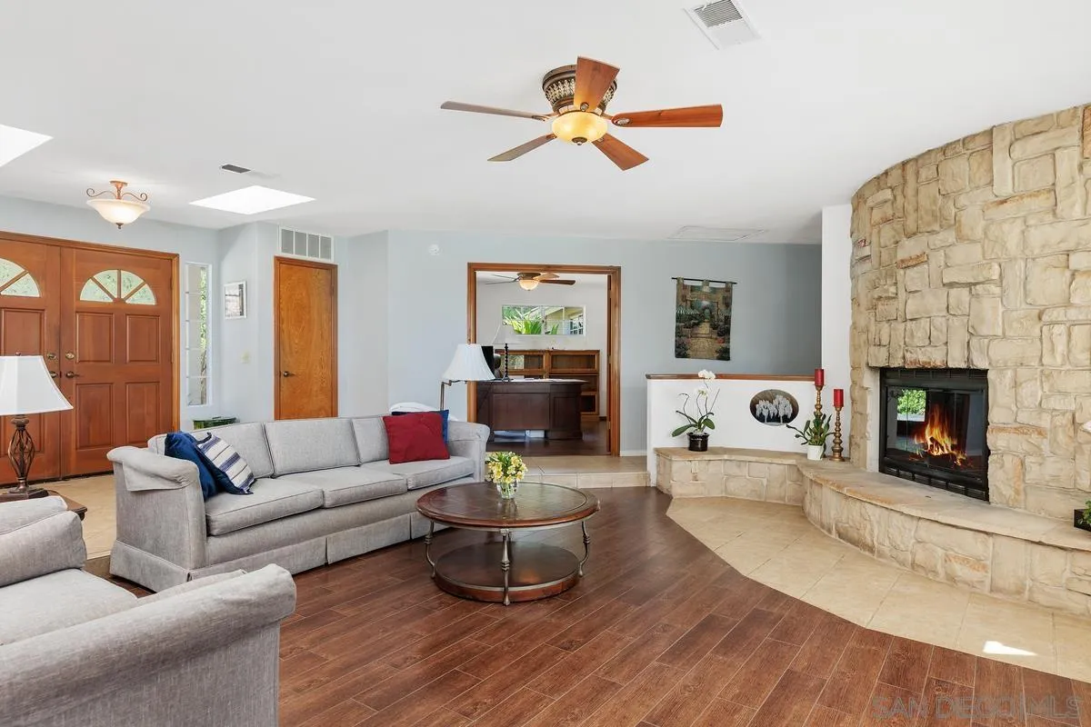 15121 Country Hill Road Poway, CA 92064 - Photo 7 of 40 a living room with furniture and a fireplace