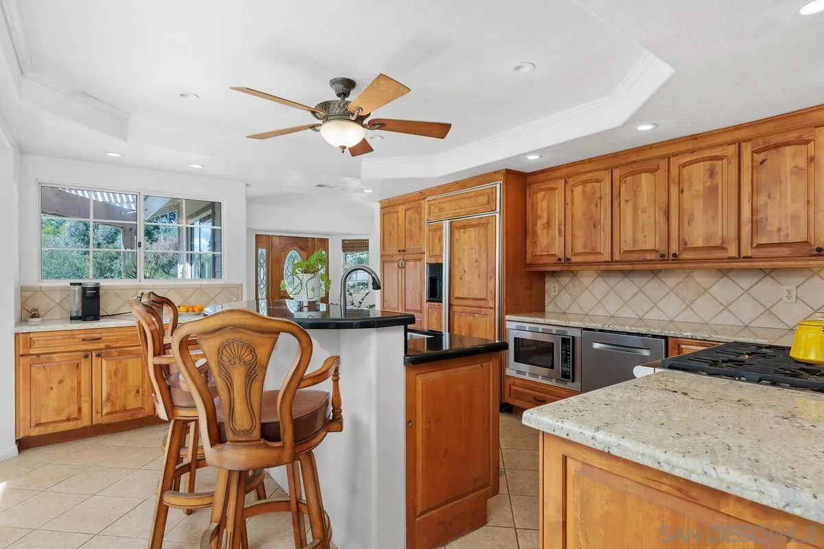 15121 Country Hill Road Poway, CA 92064 - Photo 9 of 40 a view of a kitchen area with furniture and window