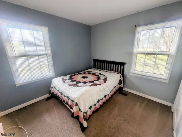 a bed sitting in a bedroom next to a window