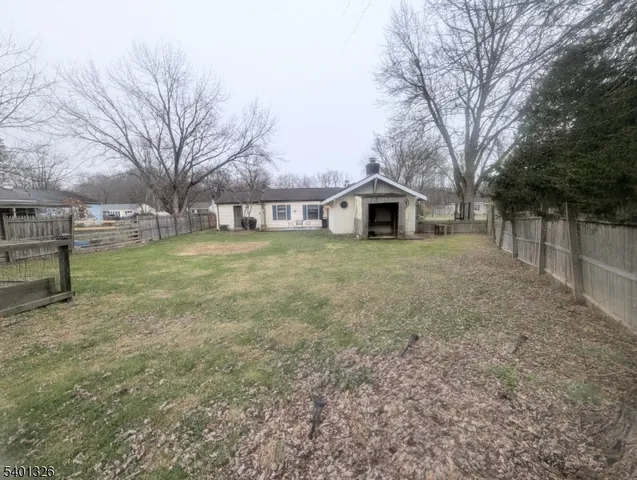 a front view of a house with a yard covered in snow