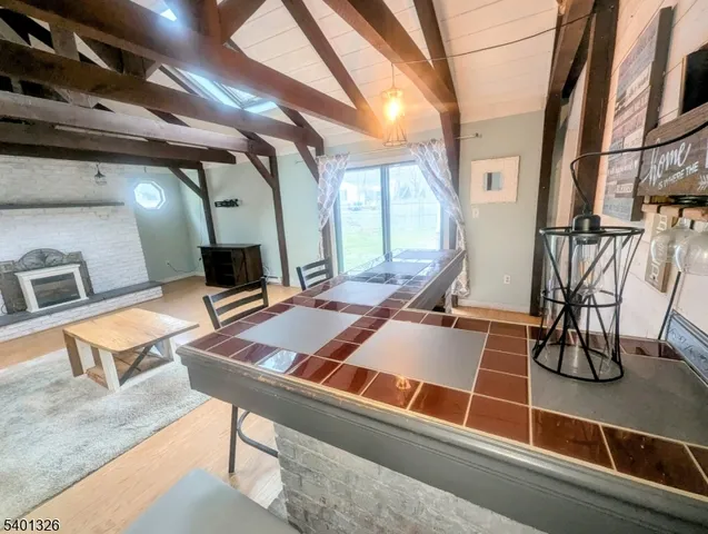 a room with table chairs and wooden floor