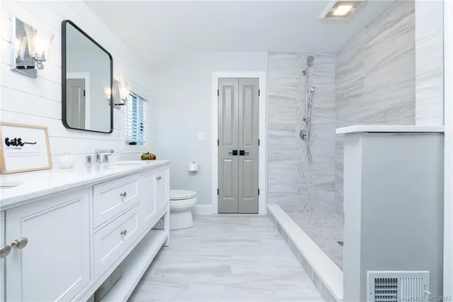 a bathroom with double vanity sink and a mirror