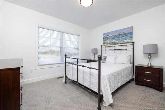 a bedroom with bed and a window