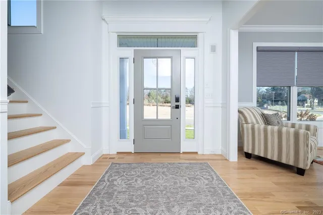 a view of entryway and hall with wooden floor