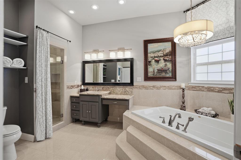 9651 Yellow Rose Lane Pilot Point, TX 76258 - Photo 22 of 38 a spacious bathroom with a tub a sink and a large mirror