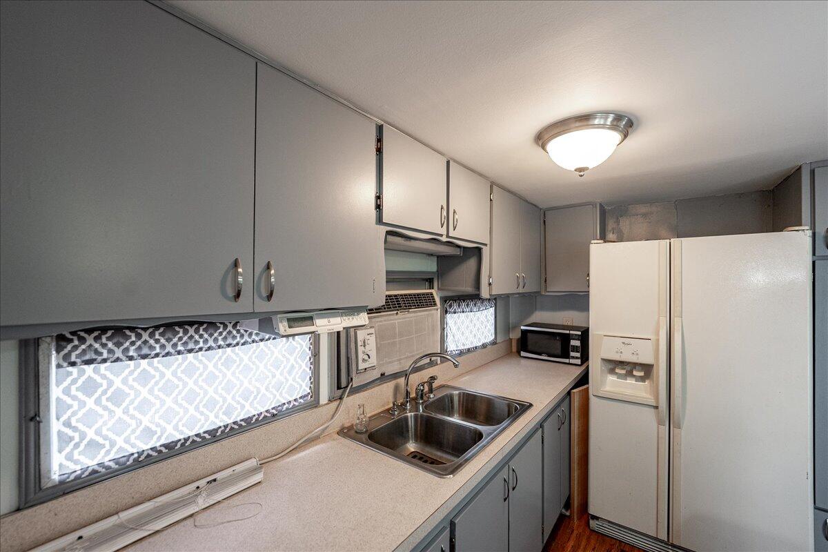 1276 Southwest Tropical Terrace Stuart, FL 34997 - Photo 11 of 27 a kitchen with a refrigerator sink and stove