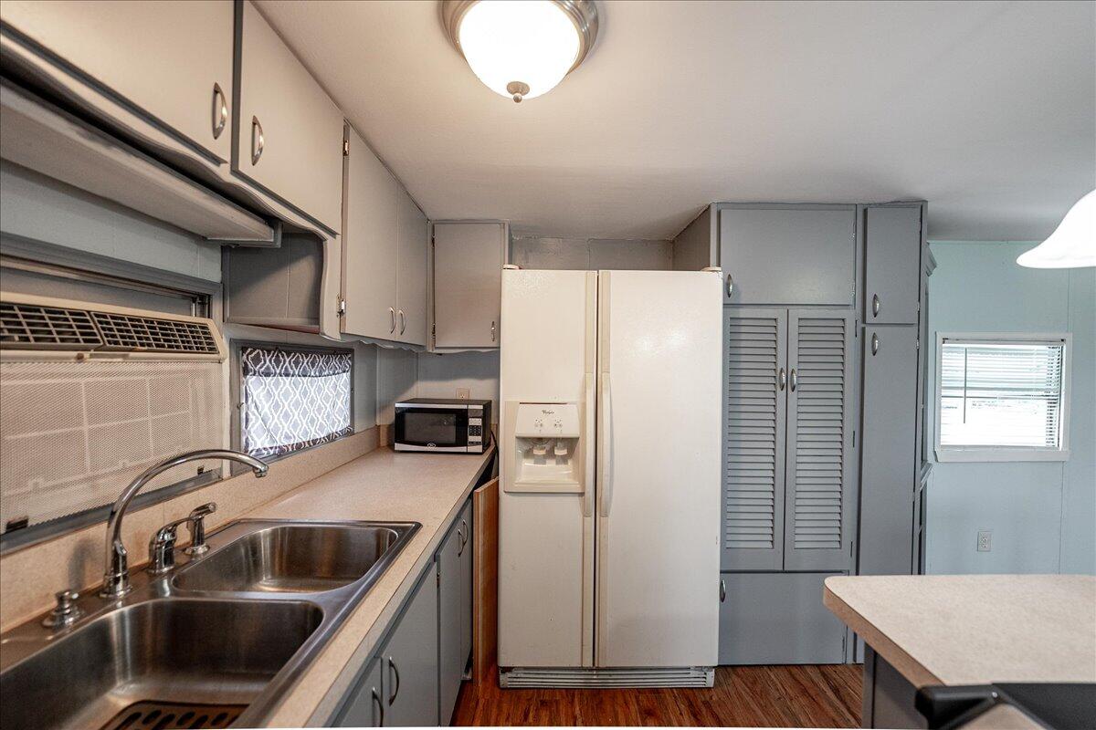 1276 Southwest Tropical Terrace Stuart, FL 34997 - Photo 12 of 27 a kitchen with stainless steel appliances a sink a stove a refrigerator cabinets and a dining table