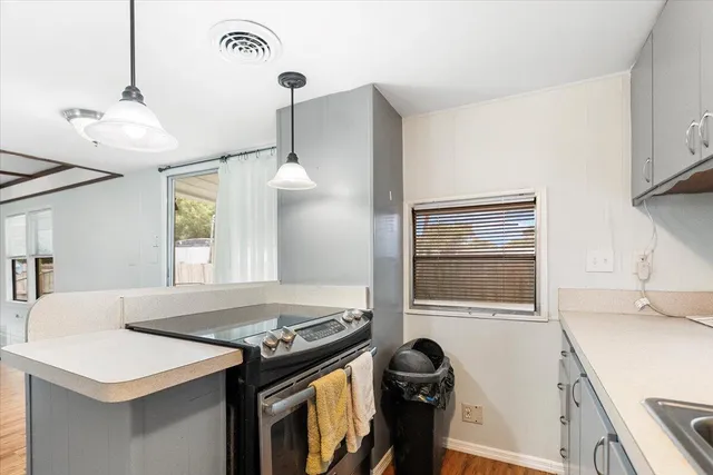 a kitchen that has a stove and a table