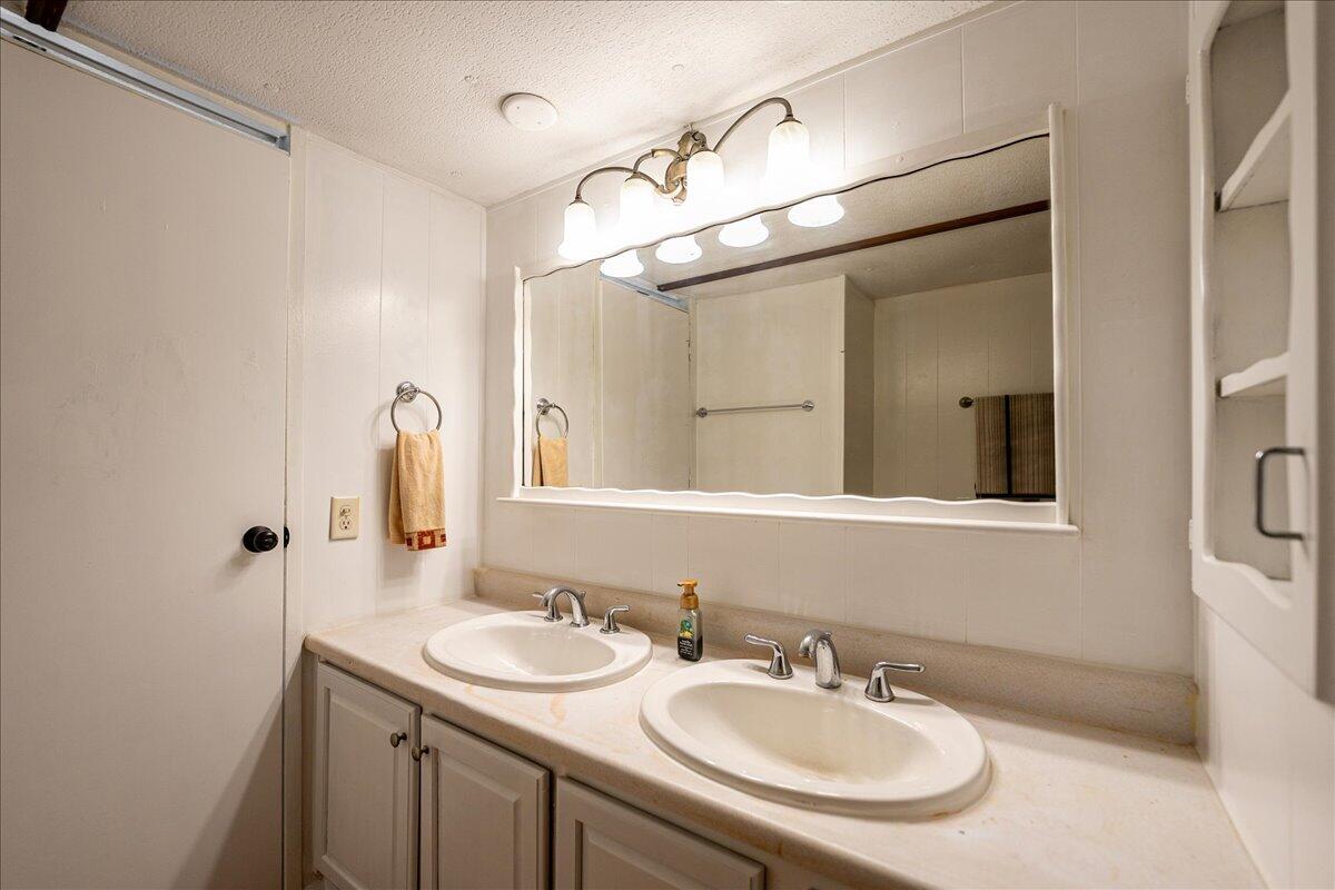1276 Southwest Tropical Terrace Stuart, FL 34997 - Photo 17 of 27 a bathroom with a sink and a mirror