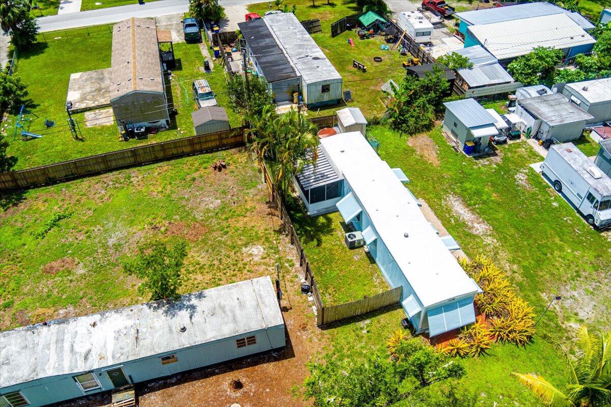 1276 Southwest Tropical Terrace Stuart, FL 34997 - Photo 23 of 27 an aerial view of a house with a garden and swimming pool