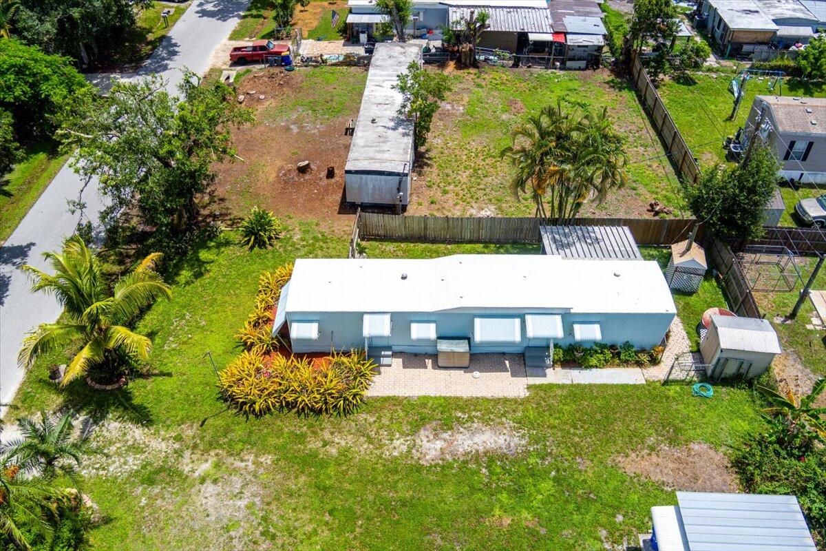 1276 Southwest Tropical Terrace Stuart, FL 34997 - Photo 24 of 27 an aerial view of a house with a garden and swimming pool