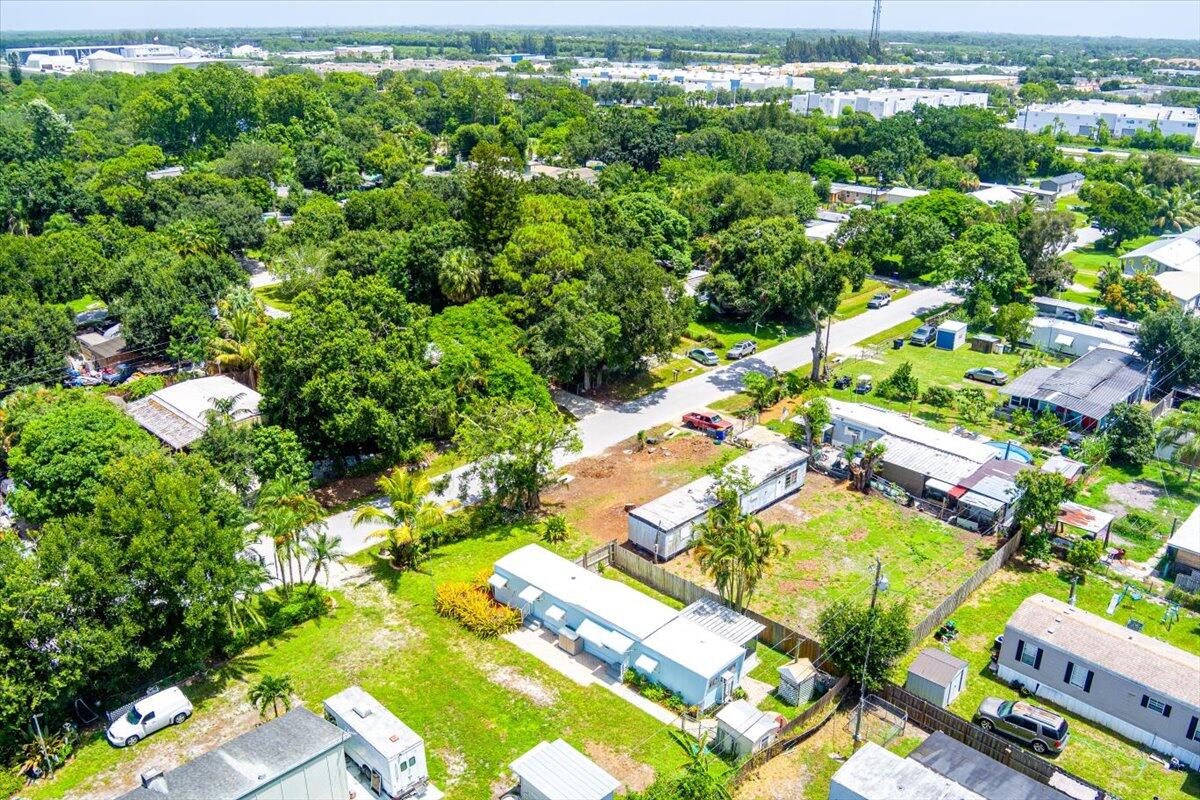 1276 Southwest Tropical Terrace Stuart, FL 34997 - Photo 25 of 27 a view of a yard with yellow plants