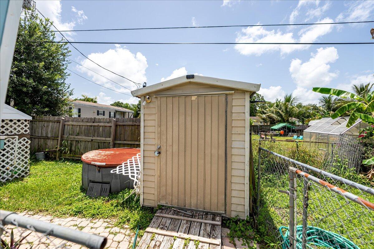 1276 Southwest Tropical Terrace Stuart, FL 34997 - Photo 5 of 27 a front view of a house with a yard
